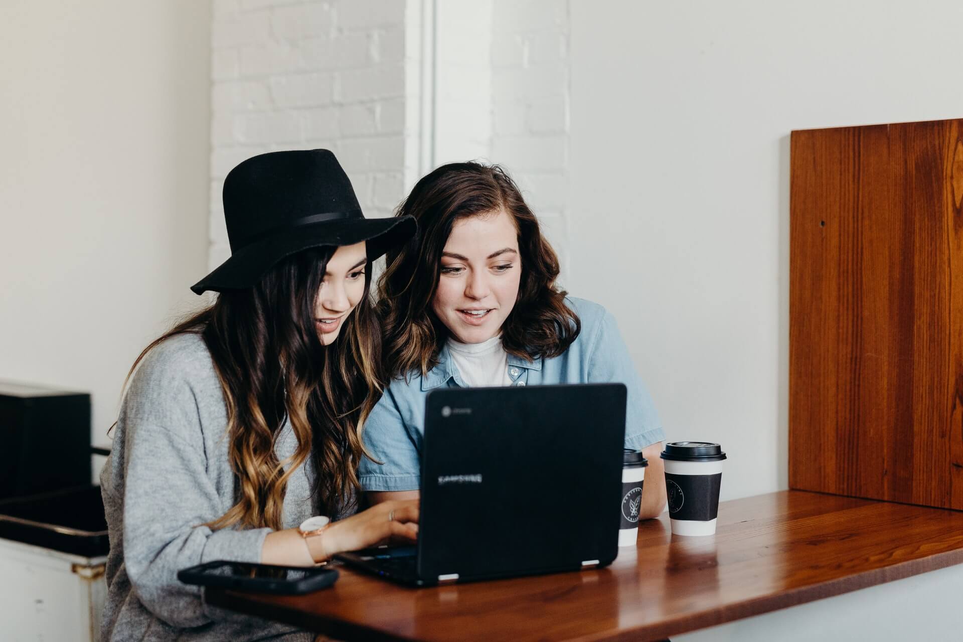 two girls in front of laptop